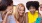 a group of women looking at a cell phone