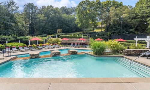 a swimming pool with trees in the background