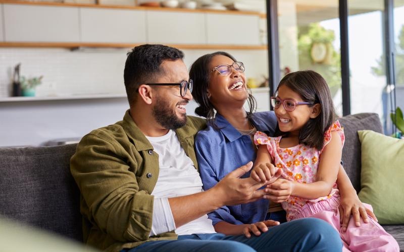 a family sitting on a couch