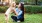a person kneeling next to a dog