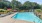 a pool with umbrellas and chairs by it