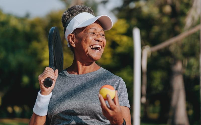 a person holding a tennis racket and a ball
