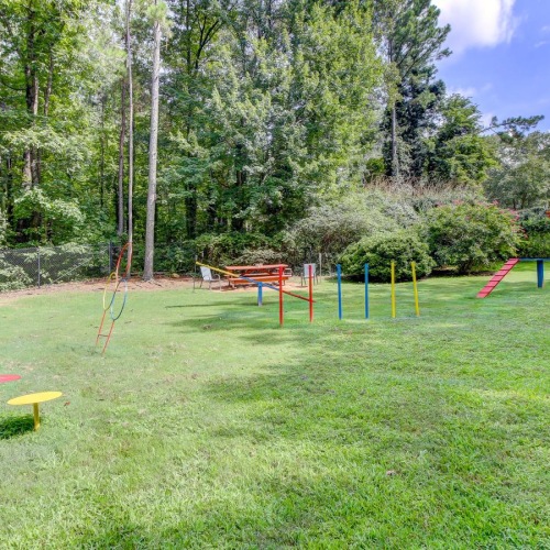 Settle into comfort at Berkshires at Vinings a grassy area with trees in the background