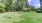 a grassy area with trees in the background