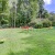 a grassy area with trees in the background