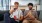 two men sitting on a couch