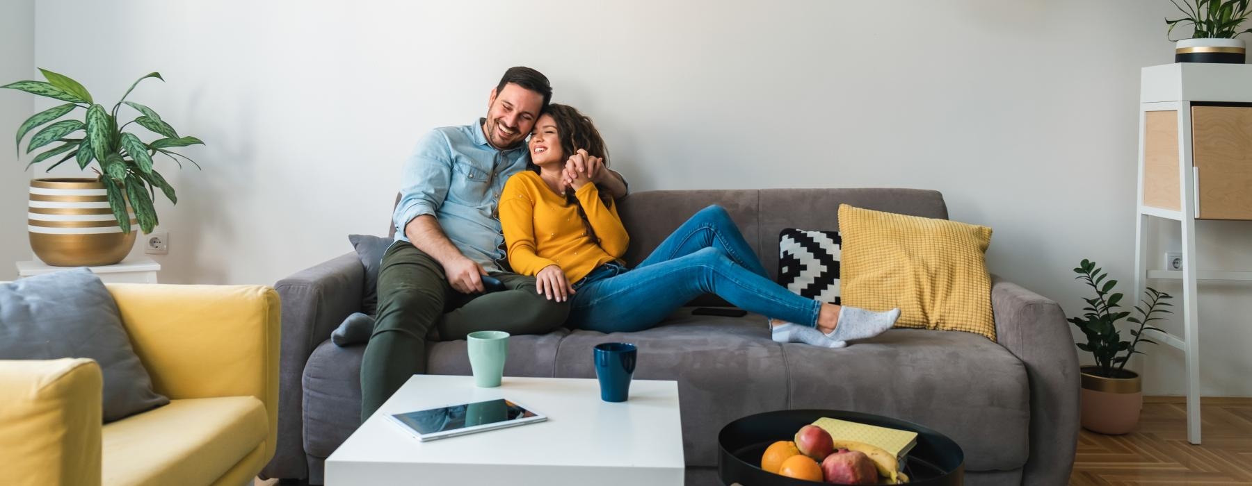 a man and woman sitting on a couch