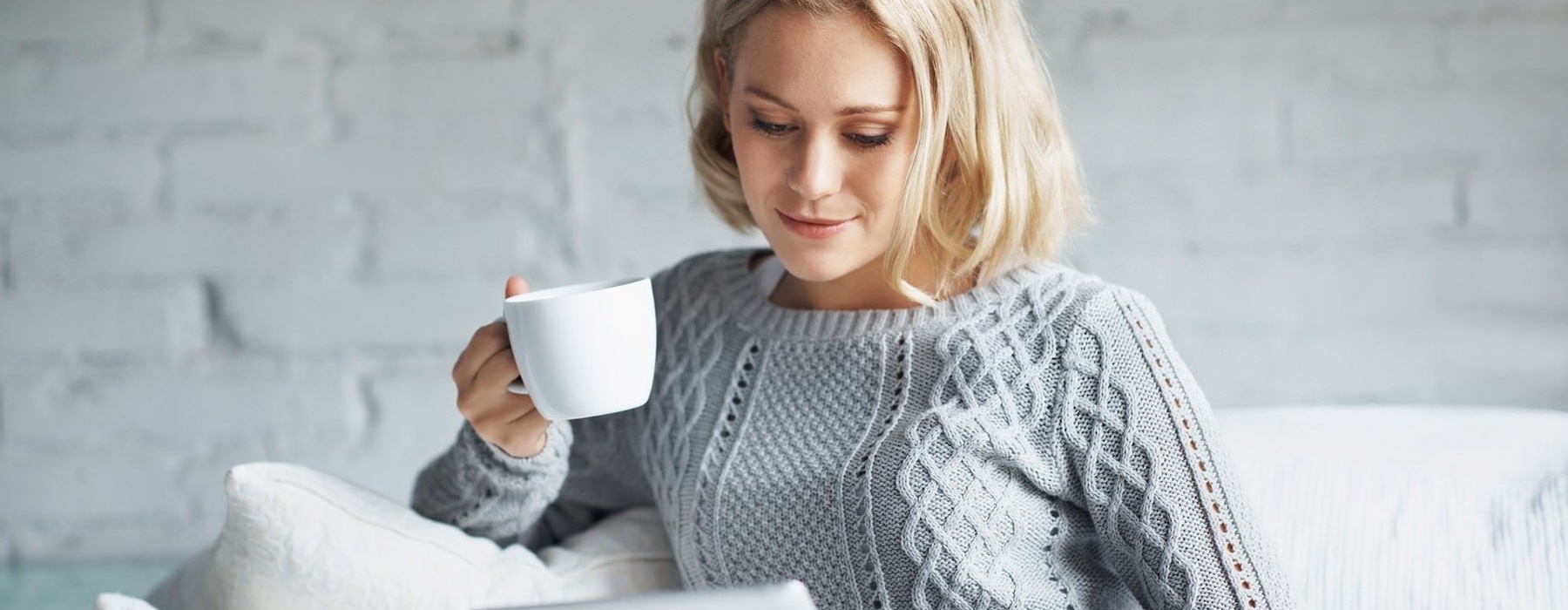a woman sitting drinking coffee