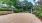 a volley ball court with trees on either side of it
